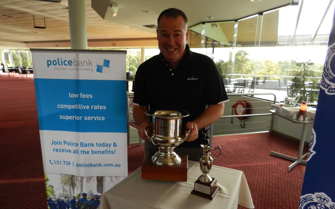 Coveted Cup: Emergency Services Golf Day organiser grasps the Cup as a member of the NSW Police Force at last year's event. 