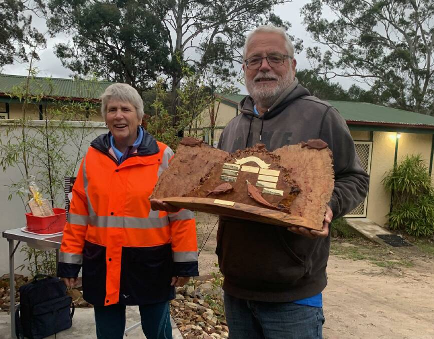 Social secretary Merrily Bell presents the Mex Williams Memorial Fishing trophy to Club President Pete Haar for taking out the Wonboyn competition with a lovely catch and release 62cm Dusky Flathead.