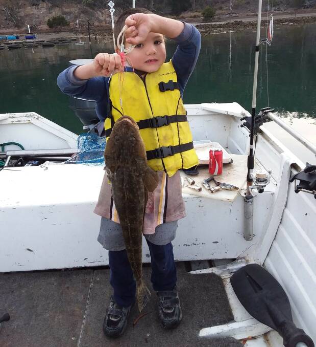 Great catch young man!: Six-year-old club member Logan Walker shows his lovely catch-and-release dusky flathead from Pambula channel. 