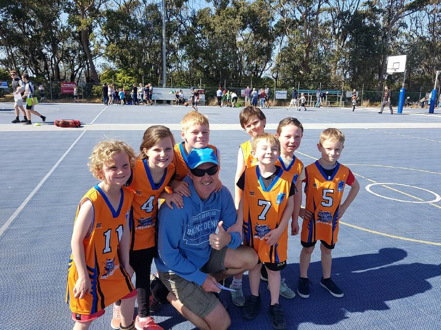 Some of the under 8s with coach Dash at the Merimbula courts. 