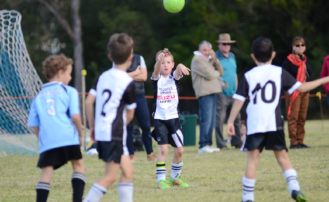 JUNIORS: Eden youngster Ralph Warren throws in to his team-mates during a junior clash with Mallacoota last season. Picture: supplied. 