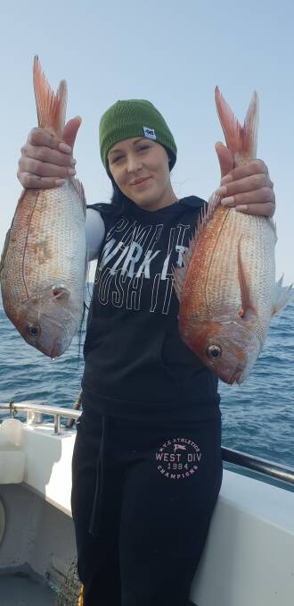 Fish dinner: Ashley Dehnert from Tumut shows a lovely pair of pan sized snapper caught off Haycock Reef.