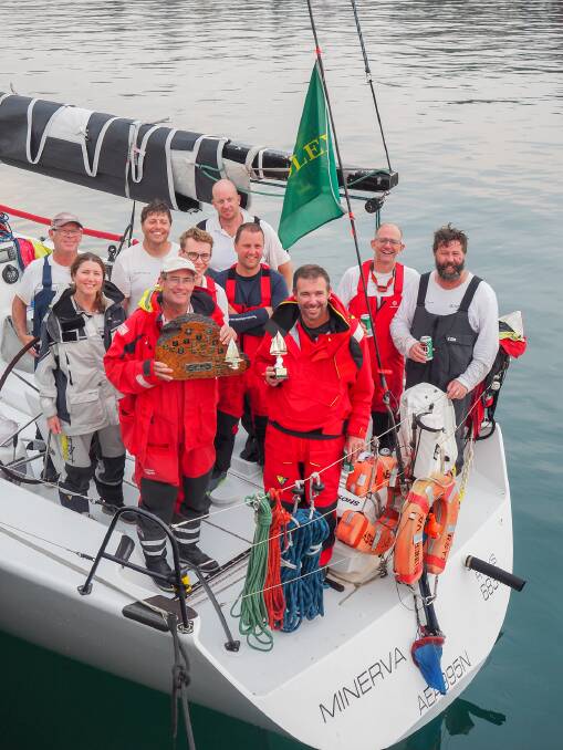 Warm reception: The Minerva crew accept the trophy as the first (and only) boat to retire from they Sydney to Hobart into Eden last year. Picture: Robyn Malcolm.