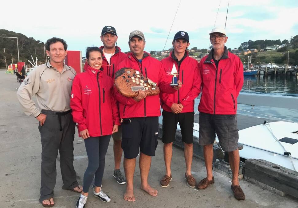 Consolation prize: Calypso crew members accept the Twofold Yacht Club's annual prize as the first boat into Twofold. Picture: Robyn Malcolm.