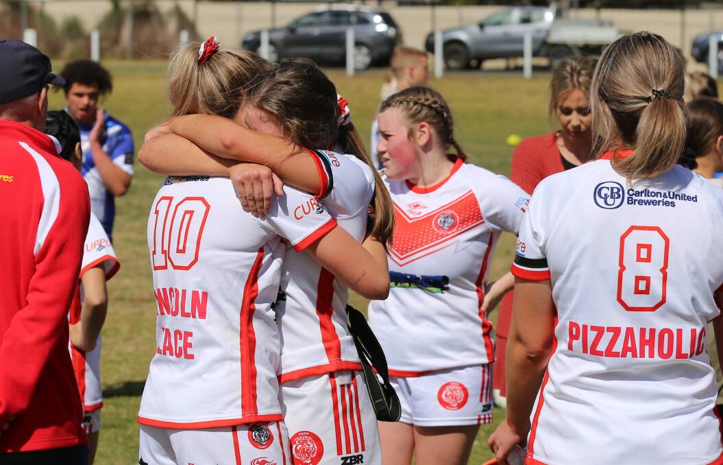 Emotions run high: Tigerettes embrace after their loss to the Bombala High Heelers on Sunday. 