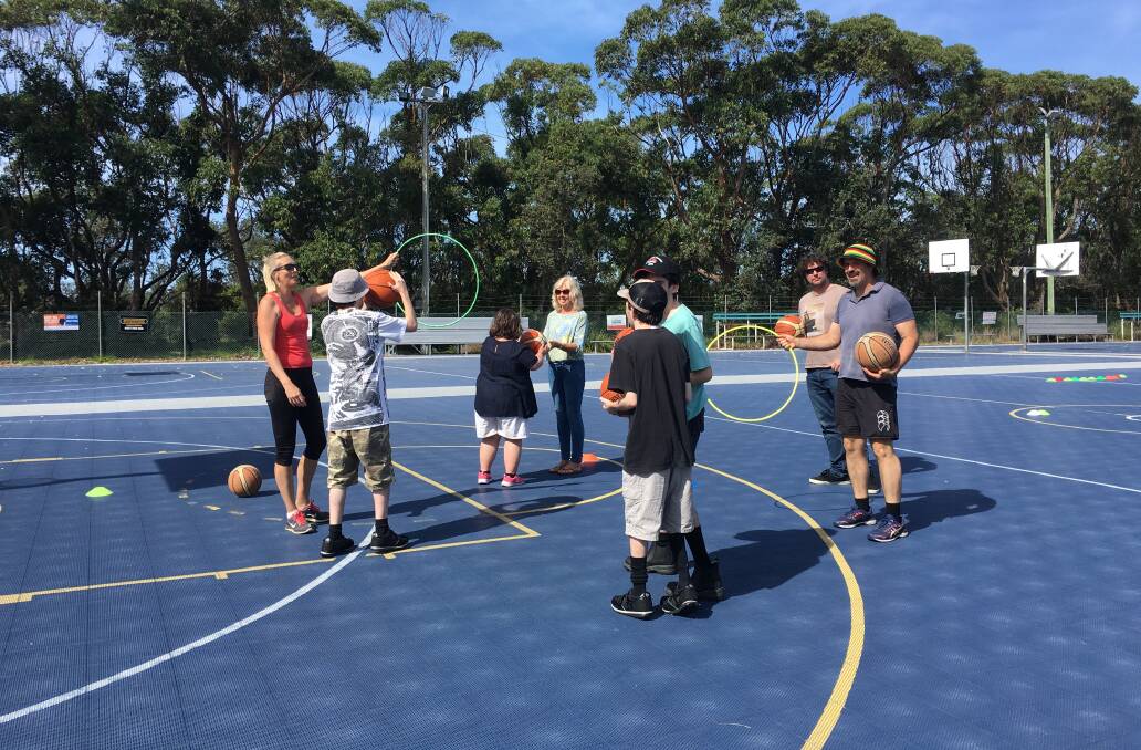 Sarah Maguire (left) runs a weekly inclusive program for kids with special needs to be able to play basketball. 