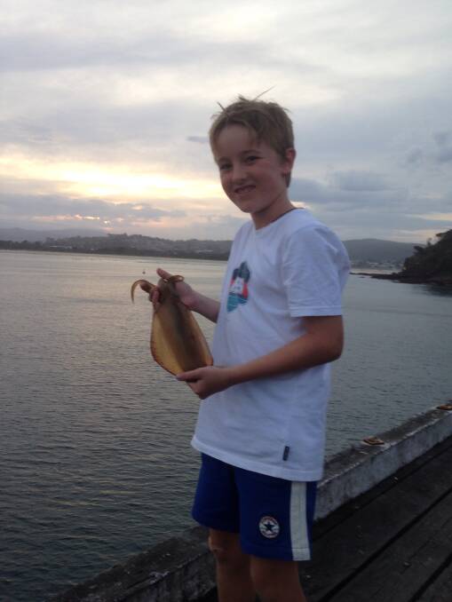 Easter catch: Merimbula's Alex Daly, 9, shows his lovely calamari squid taken at the Merimbula Wharf at sunset on Easter Sunday.