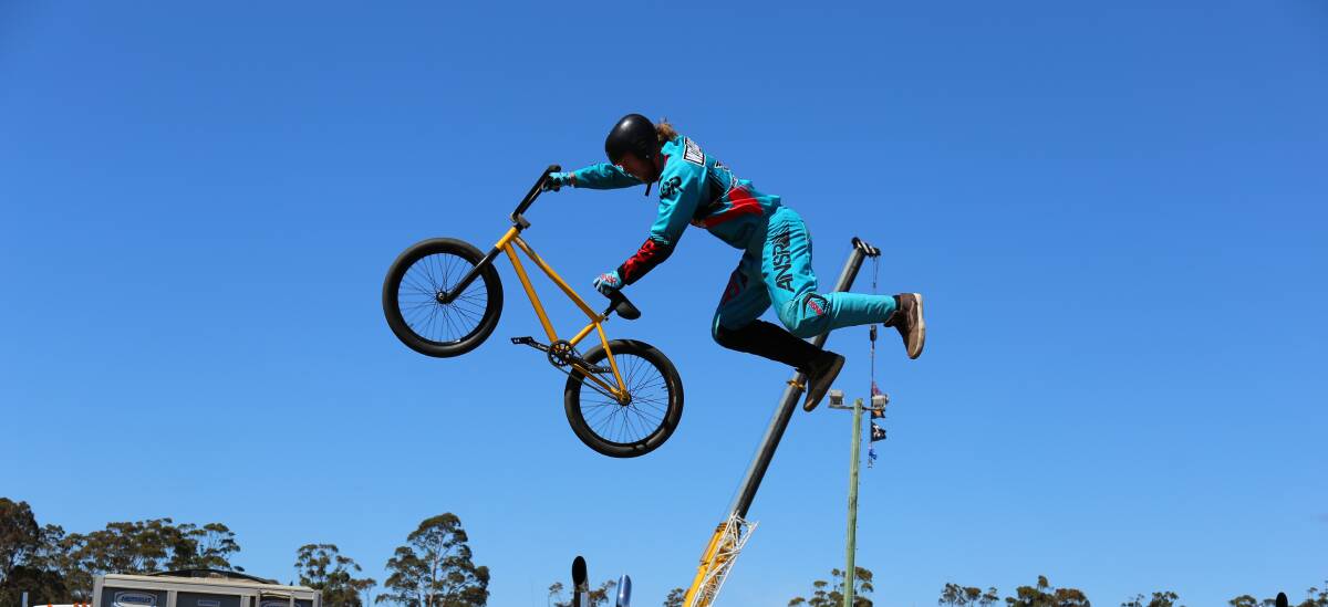High-flier: Josh Williams launches into a seat grab trick during one of the Flair Stunt Action Riders sets at the Pambula Motorfest. 