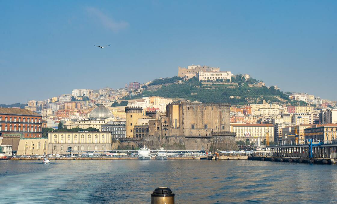 The New Castle in the foreground with Saint Elmo Castle high on a hill above Naples
