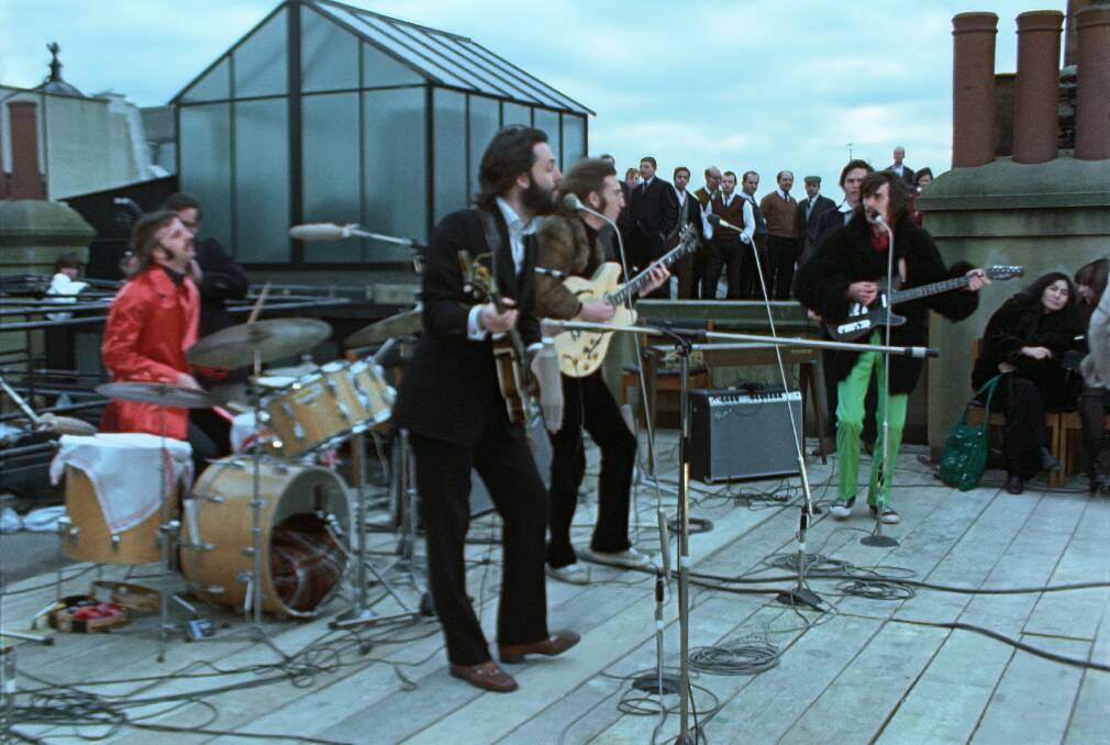 The Beatles perform an impromptu concert on a London rooftop in 1969. Picture: Disney+