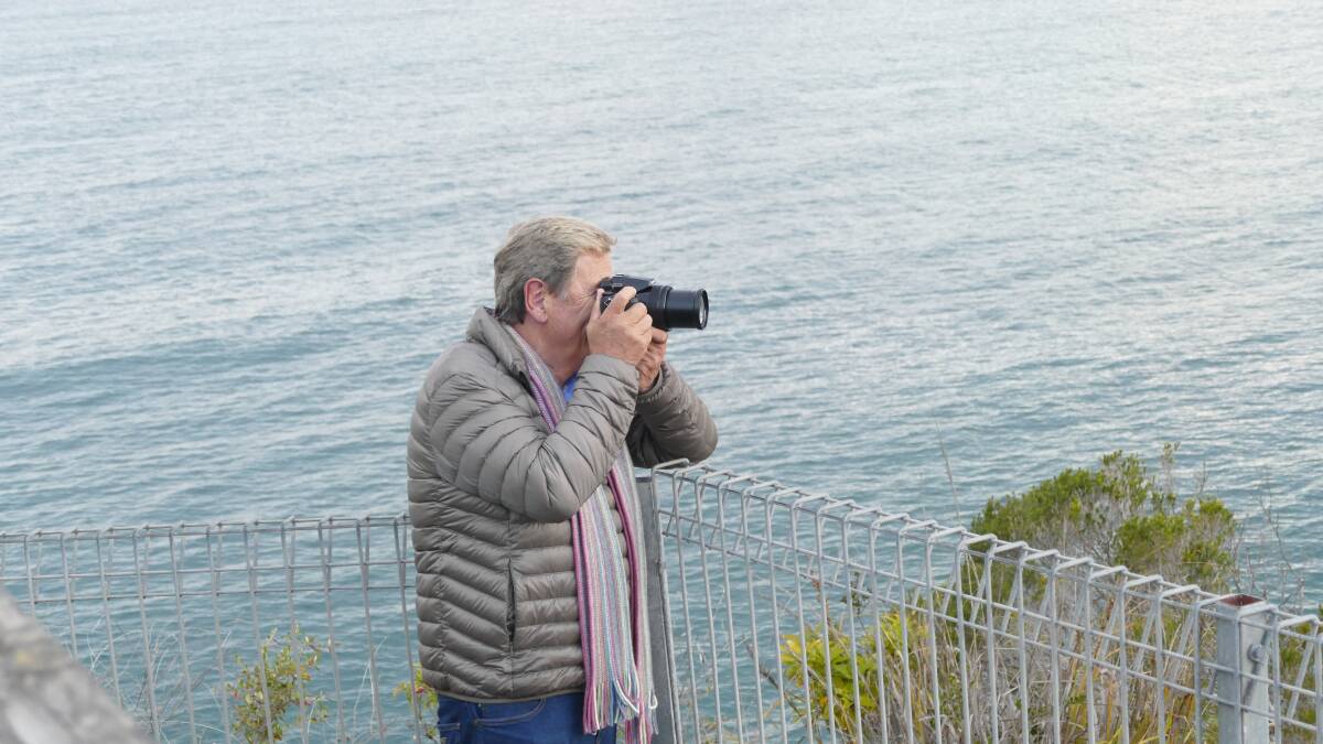 SNAPPED: Australian television presenter Ray Martin caught the eye of a few locals as he captured the view over Eden's Twofold Bay. Photo: Joanne Korner