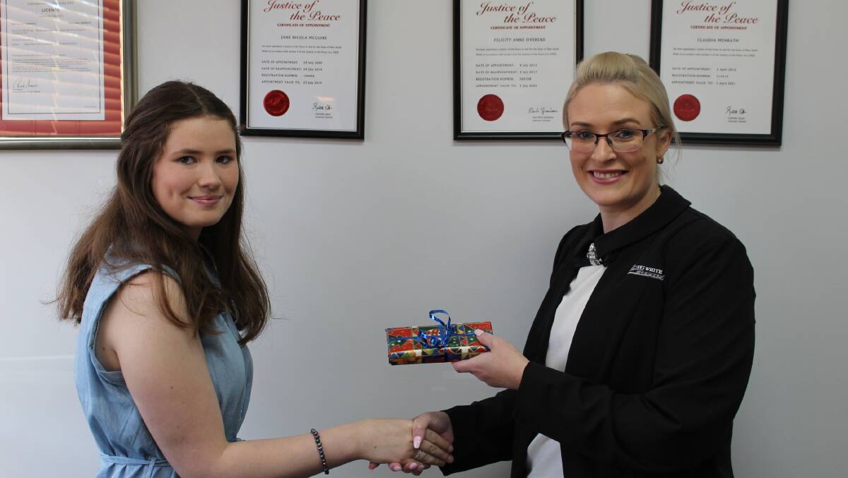 TOP STUDENT: EMHS student Jaid Boundy is presented with a gift from Sautelle White Lawyers Merimbula partner Carmen Thomson for excellence in legal studies.