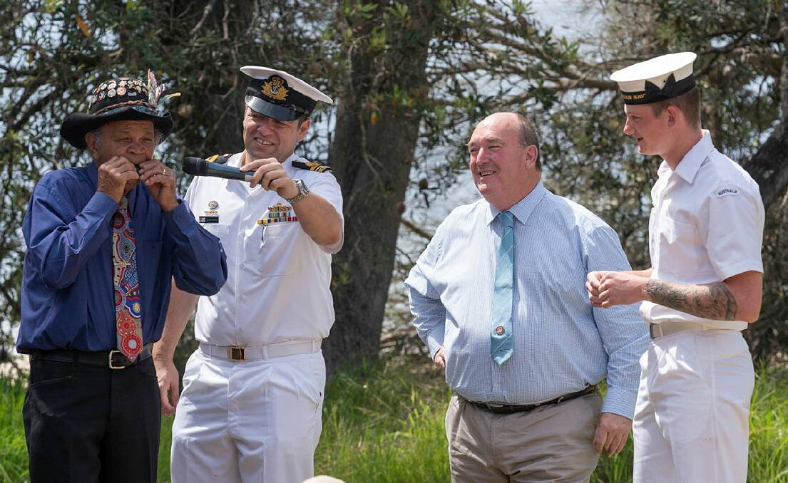 Yuin Elder Ossie Cruse AM MBE, plays "I Am Australian", on a gum leaf with NUSHIP Supply Executive Officer Lieutenant Commander Peter Dargan, RAN, Bega Valley Shire Council Mayor Russell Fitzpatrick and Seaman Boatswain Mate Max Betts during the event announcing the Port of Eden as NUSHIP Supply's ceremonial homeport in Eden. Photo: Commonwealth of Australia