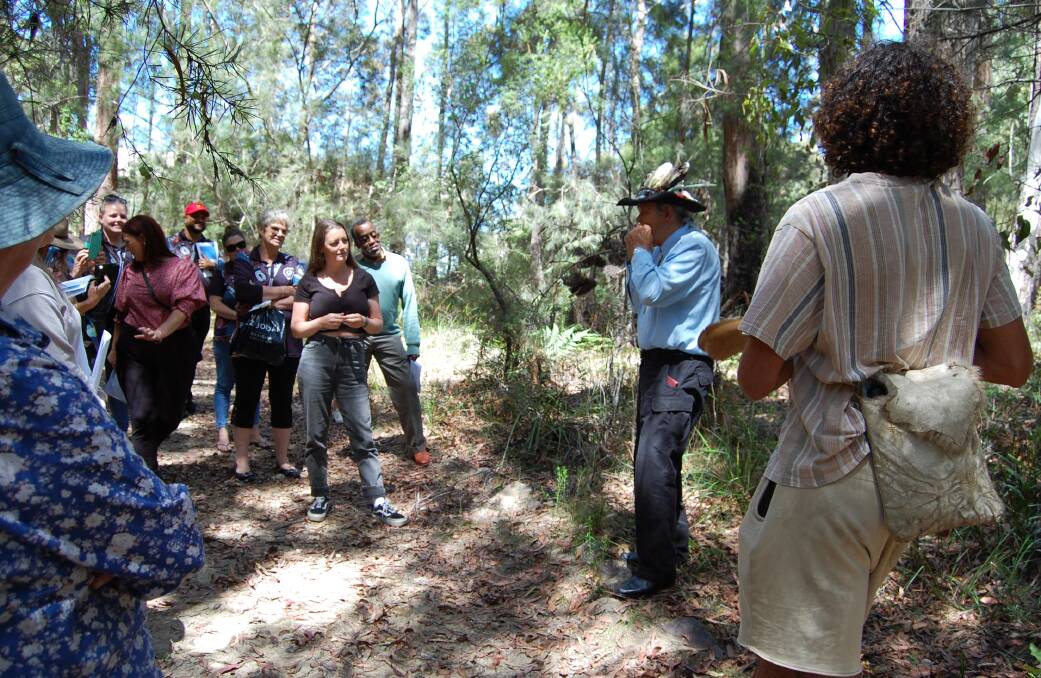 On the culture walk, Elder Uncle Ossie Cruse shared with the group how he manages to get a tune out of a gum leaf. Photo: Leah Szanto