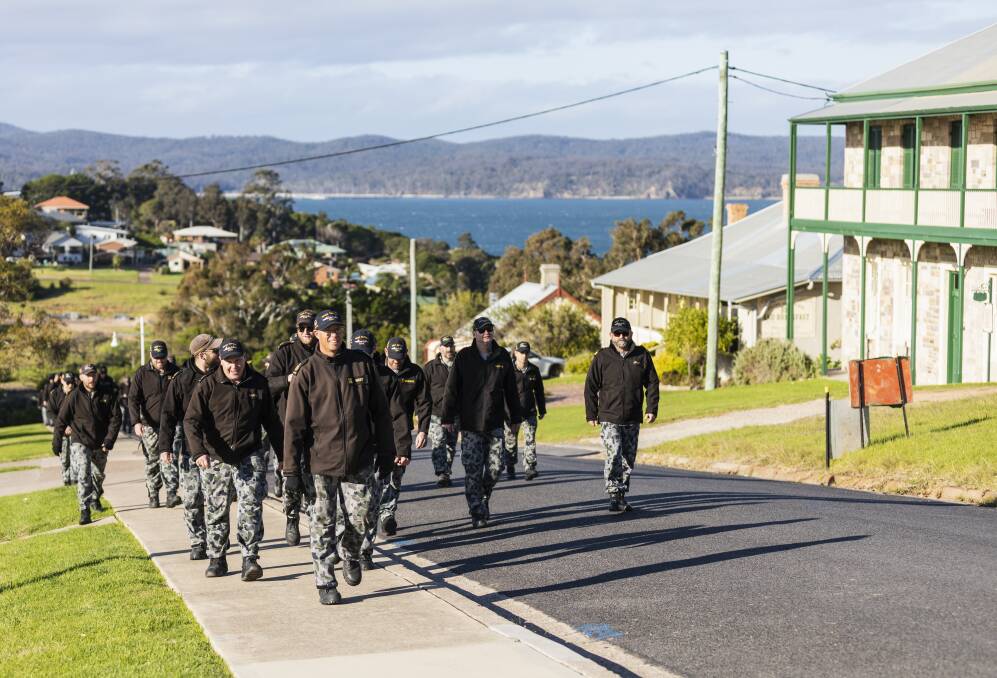HMAS Supply Ships Company make their way into the town of Eden, New South Wales, to support local businesses and interact with locals. Photo: Department of Defence.
