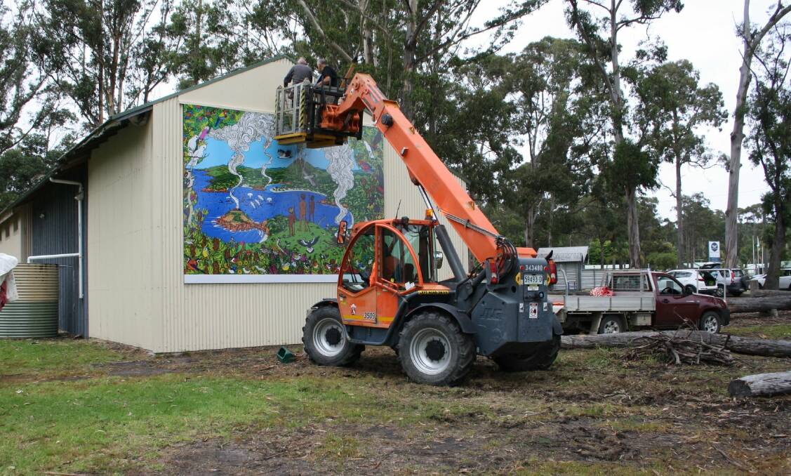 The mural being fixed to the Scout Hall. Photo: supplied