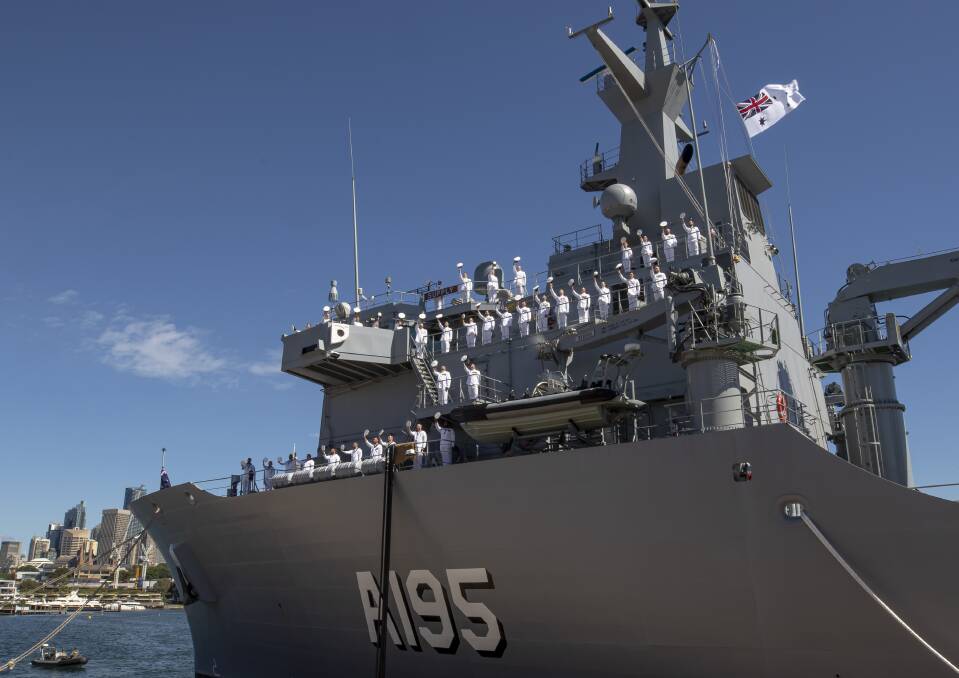 HMAS Supply ship's company line the upper decks on completion of her commissioning ceremony at Fleet Base East in Sydney, New South Wales.
Photo: Defence.