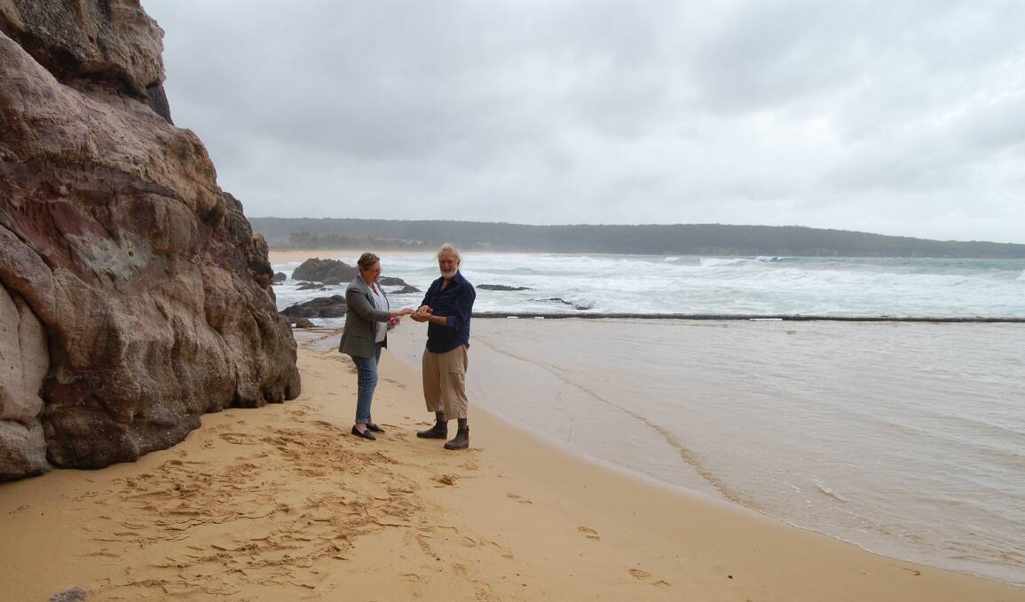 Angela George and Peter Whiter inspect the build up of sand in the Aslings Beach ocean pool. Photo: Leah Szanto