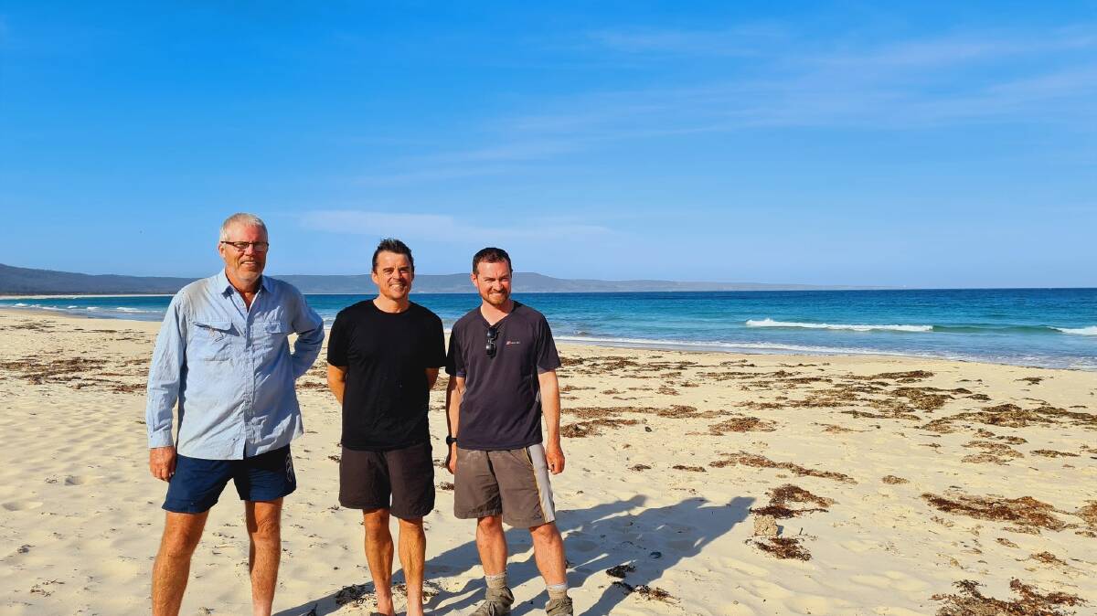 Kent Holman, Daniel Loader and Paul McKee at the end of their 580km walk, taken at the Nadgee end of Disaster Bay after walking the Light to Light track. Photo: supplied