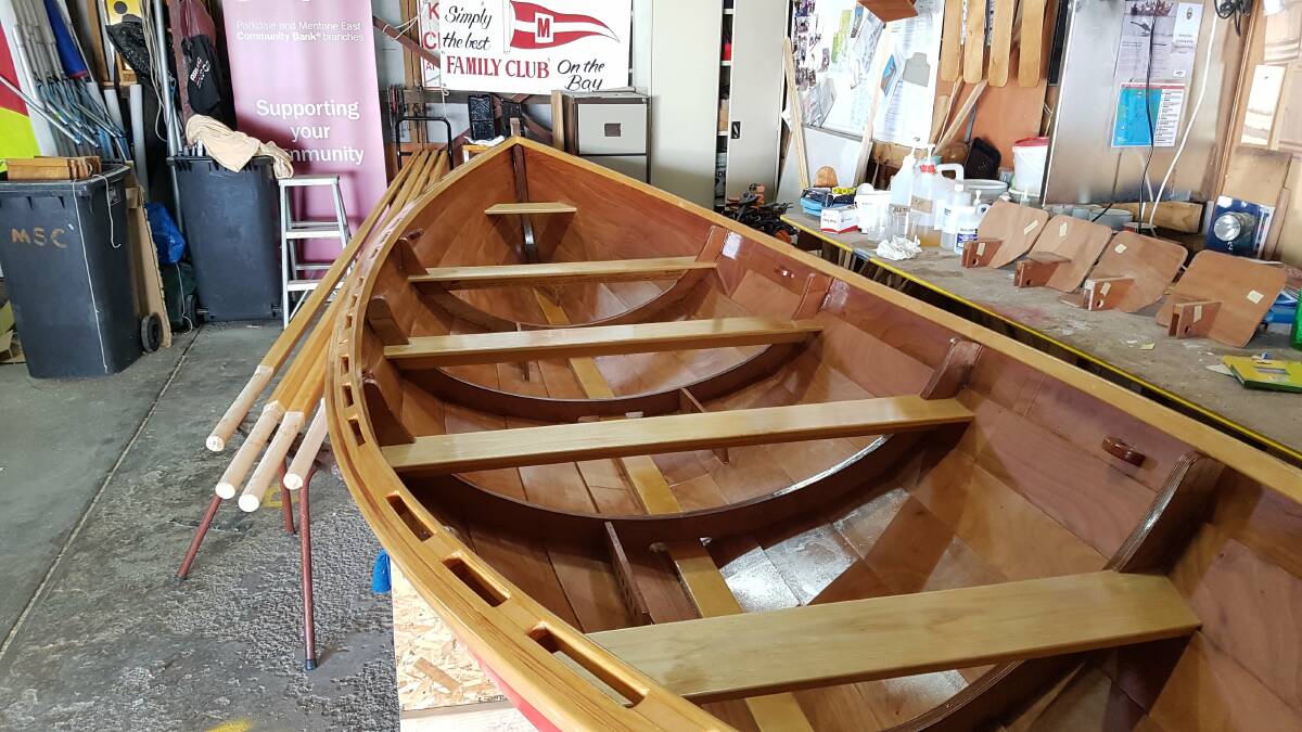 An example of the boat to be constructed, a St Ayles Skiff, a 22-foot four-oared rowing boat, resembling whalers that were used on Twofold Bay. Photo: Mordialloc Sailing Club