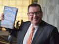 NZ Finance Minister Grant Robertson with the budget that aims to deliver on two election promises.