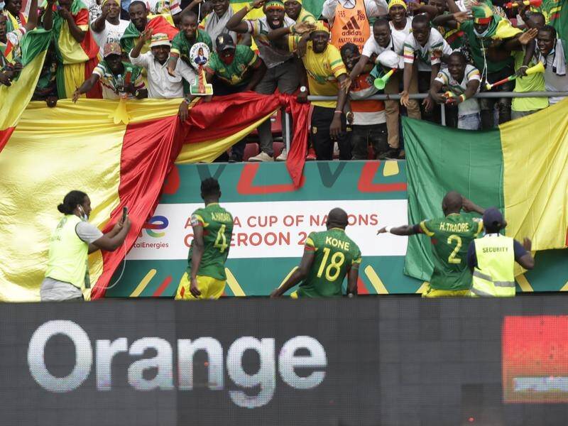 Ibrahima Kone and his teammates celebrate with Mali fans after his goal against Gambia in Limbe.