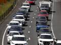 The price of new cars, higher interest rates and insurance premiums are pushing up transport costs. (Jason O'BRIEN/AAP PHOTOS)