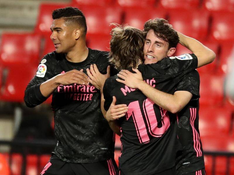 Alvaro Odriozola (r) celebrates his goal with Real Madrid teammates Luka Modric and Carlos Casemiro.