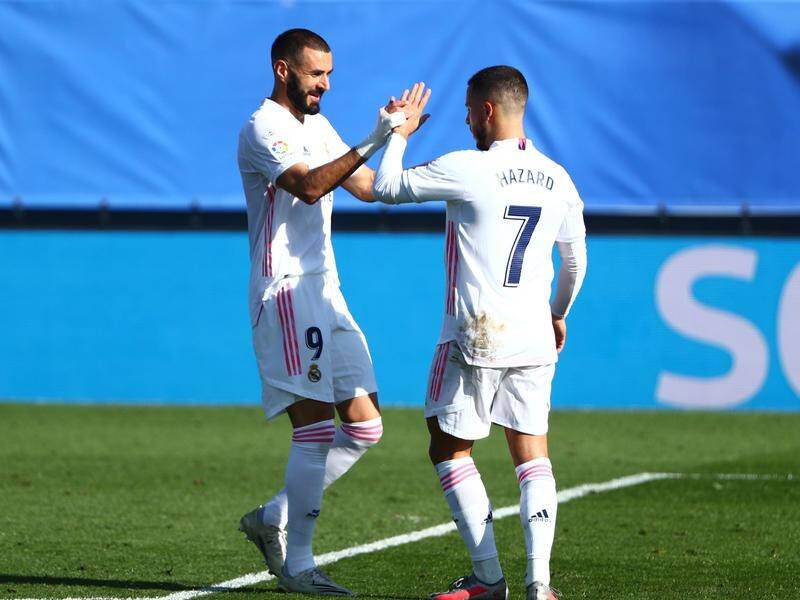 Real's No.7 Eden Hazard being congratulated on his first goal for over a year by Karim Benzema.