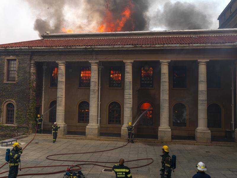 Firefighters are battling a blaze that has destroyed several University of Cape Town buildings.