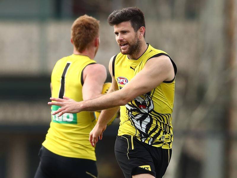Tiger Trent Cotchin (r) will miss the crunch AFL clash against the Eagles and will return next week.
