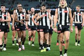 Darcy Moore leads his Collingwood teammates from the field after defeat by the Western Bulldogs. (Joel Carrett/AAP PHOTOS)