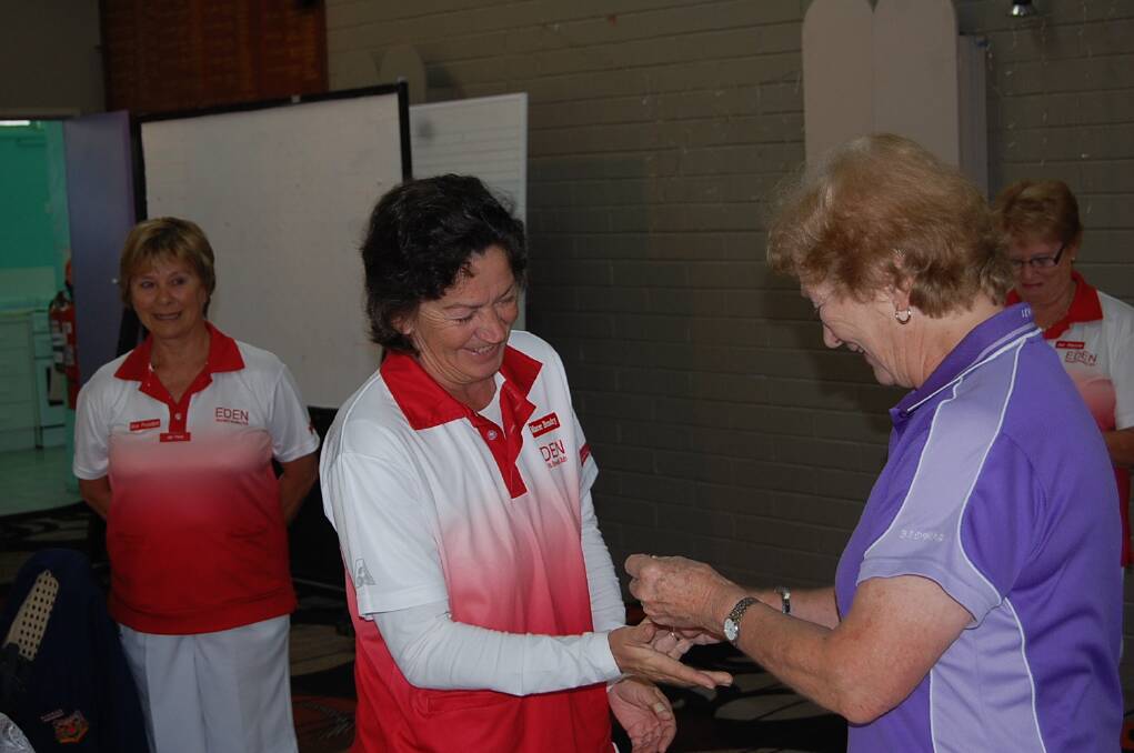 District president Beryl McGrath-Smith presents Maree Hendry with her winner’s badge.