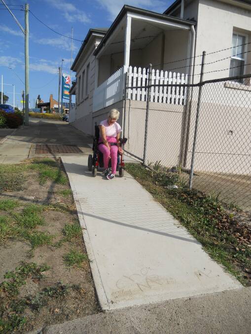 Eden resident Ingrid Grigors inspects the new section of footpath in Imlay Street.Source: supplied
