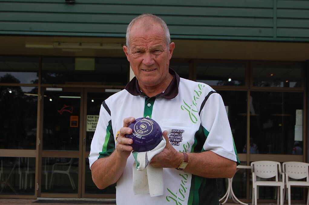 Frank Peniguel polishes a bowl as he prepares to play at the Eden Gardens Country club; number 144 in his Guinness World Record attempt.