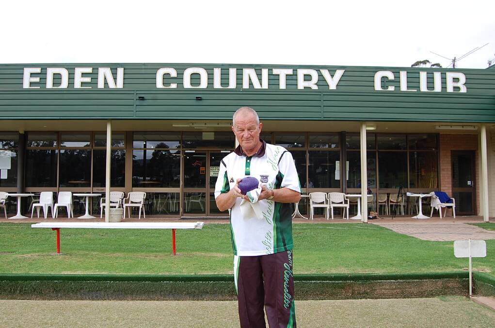 Frank Peniguel polishes a bowl as he prepares to play at the Eden Gardens Country club; number 144 in his Guinness World Record attempt.