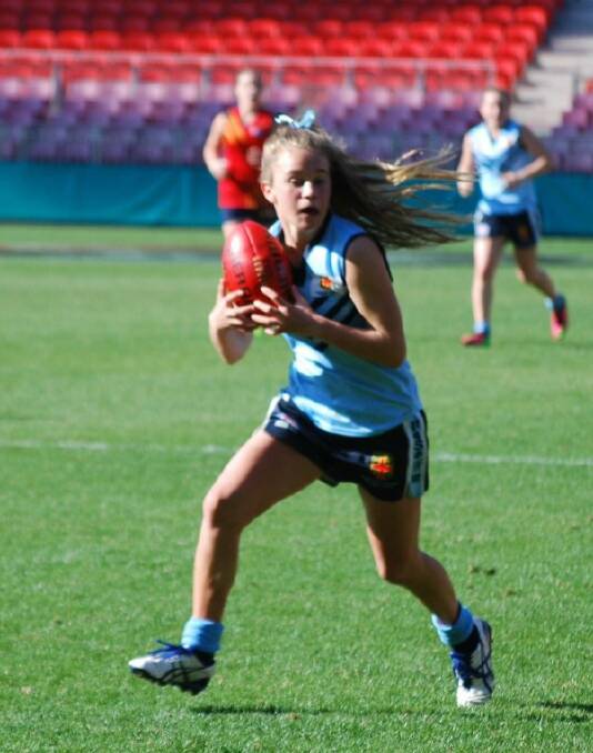 Eden Marine High School student and rising Aussie rules star Dakota Hooper takes a contested mark for NSW against South Australia, during a match where she was named best on ground at the recent national school championships in Sydney.
