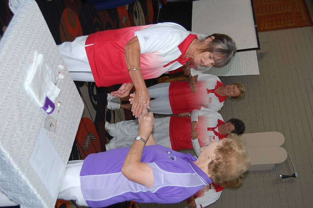 Robyn Symonds shakes hands with district president Beryl McGrath-Smith during winner’s badge presentations on Tuesday morning.