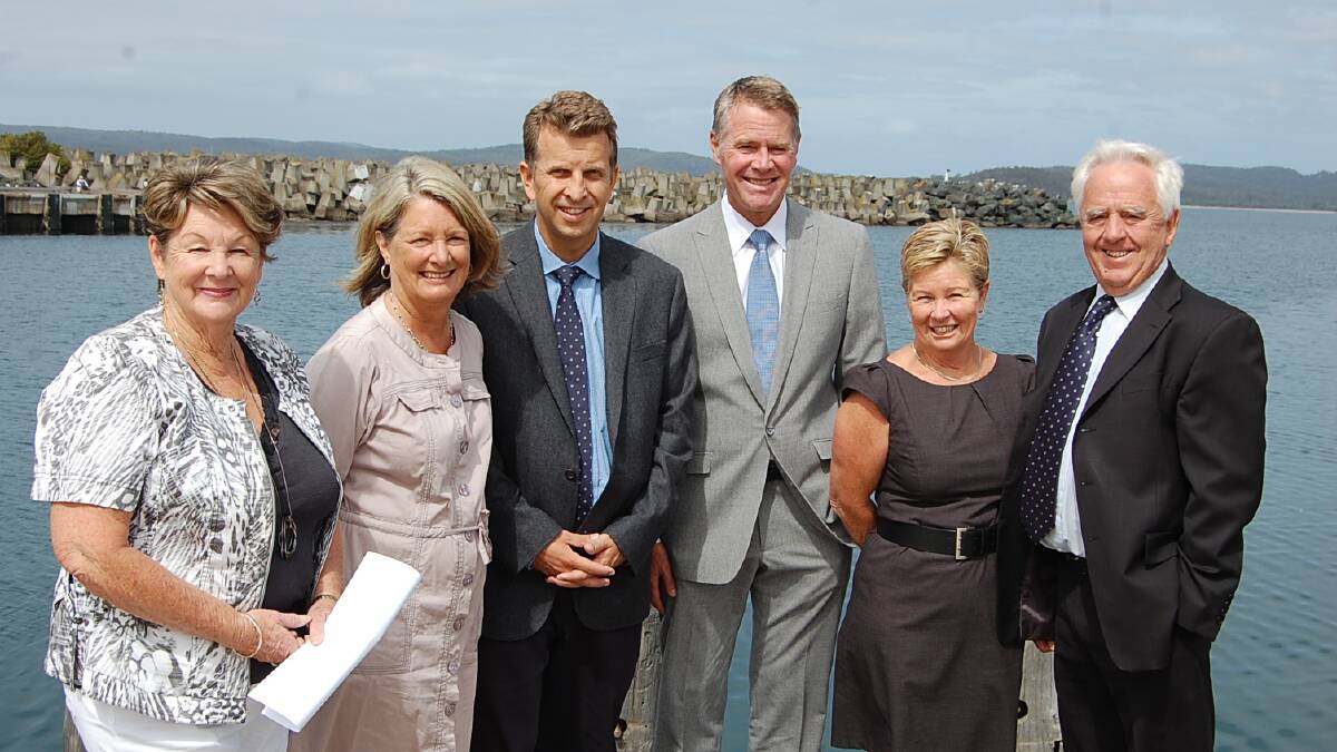  Cruise Eden representatives (from left) Marge Snijder and Gail Ward, with Member for Bega Andrew Constance, Deputy Premier Andrew Stoner, Sapphire Coast Tourism board member Jenny Robb, and Bega Valley Shire mayor Bill Taylor in front of the breakwater wharf that will be extended thanks to the new funding.