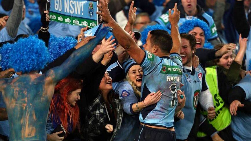 NSW fullback Jarryd Hayne celebrates the Blues' first State of Origin triumph since 2005 with ecstatic fans at ANZ Stadium, Sydney.
