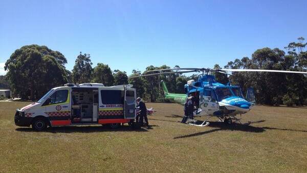 The Snowy Hydro SouthCare Rescue Helicopter lands next to the Princes Highway at Eden early on Monday afternoon.