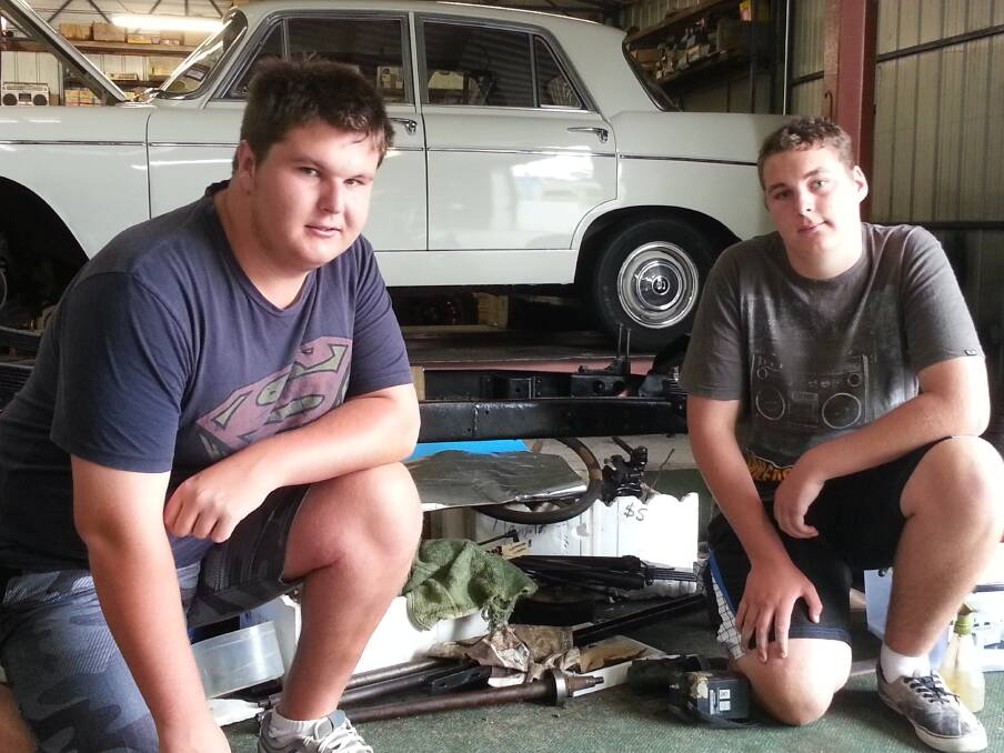 Year 10 Eden High students Christopher Love (left) and Cody Schroeder are working on restoring a 1923 5CV Citroen with the help of the Sapphire Coast Historic Vehicle Club’s mentoring program.