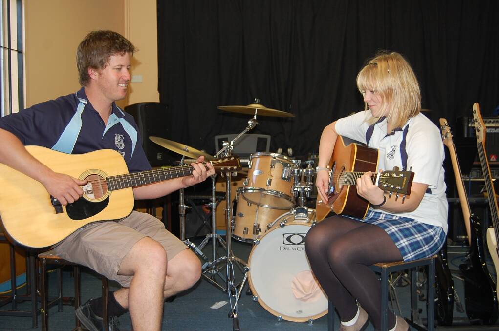 Emily Claxton and Eden Marine High School music teacher Sam Martin knock out a tune.