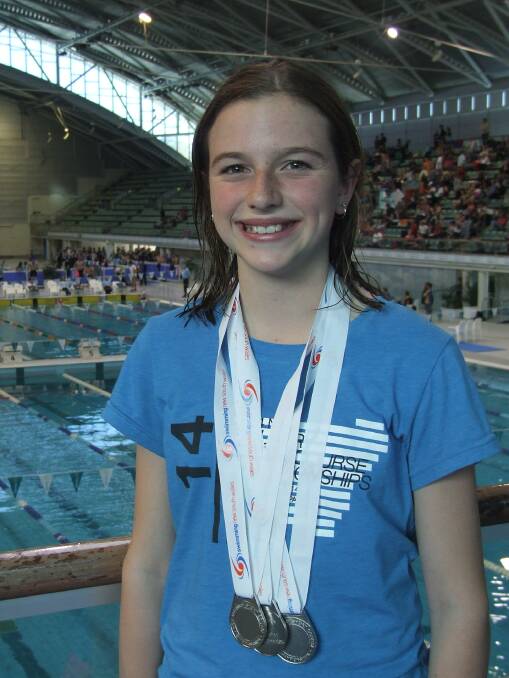• Eden’s Georgia Caldwell shows off her three silver medals she won at the SNW Country Swimming Championships in Sydney on Sunday. 