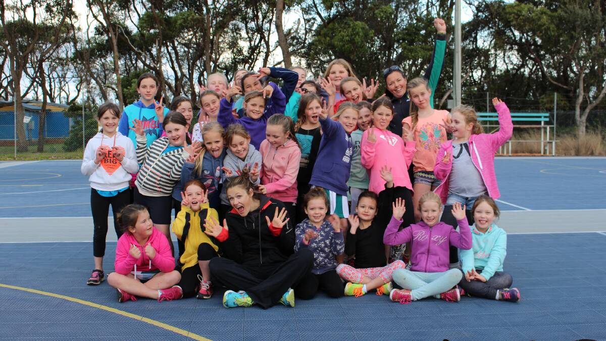 • Former Sapphire netballer, and NSW Swifts star, Susan Pratley throws up a cheer with 30 students at a netball training clinic last week. 