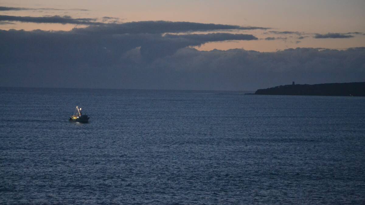 Moon set, sun rise in Eden on Wednesday morning as the fishing trawler Melisa headed home after three days at sea.
