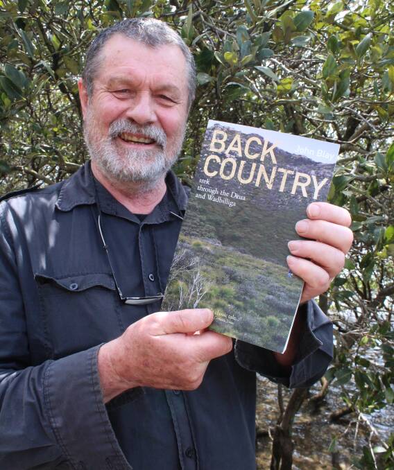 WILD AT HEART: Author John Blay of Eden with his re-released book Back Country: Trek through the Deua and Wadbilliga, Monday December 5. Picture: Toni Houston