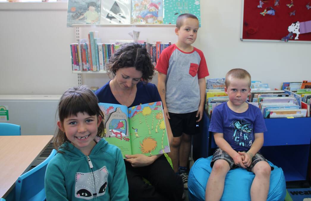 Storytime: Customer and information officer at Eden Library Cath McLean reads Dr Seuss’ classic children’s book The Lorax to Tori Brereton, 7,  Luke Fraser, 9 and Jackson Fraser, 7.  Picture: Liz Tickner