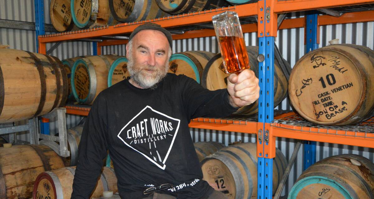 WHISKY PLEASE: Craft Works Distillery owner Craig 'Crafty' Field with Project Ian. Photo: ALANNA TOMAZIN.