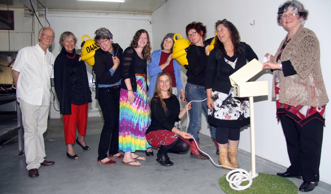 Girls and buoys: Convener of the ANU Field Studies program John Reid, alumni Dianna Budd with artists Dierdre Pearce, Carrell Hambrick, Liz Coates, Heike Qualitz, Fran Ifould, Kerry Shepherdson and (front) educational project manager Amelia Zaraftis at the opening on Friday night. The group poses with Diedre Pearce's work 'dis-placed 2013'.